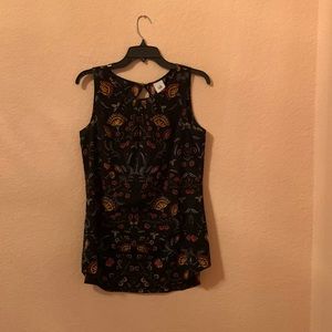 CAbi Legend Blouse (Item 3621) Black background with folkloric print.